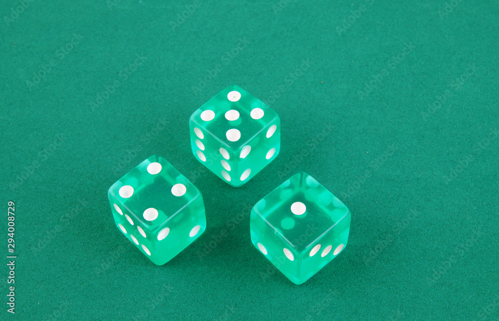 Three dices on green gaming table Three dices on green gaming table