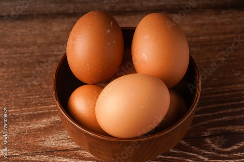 A carton of eggs on a wooden background