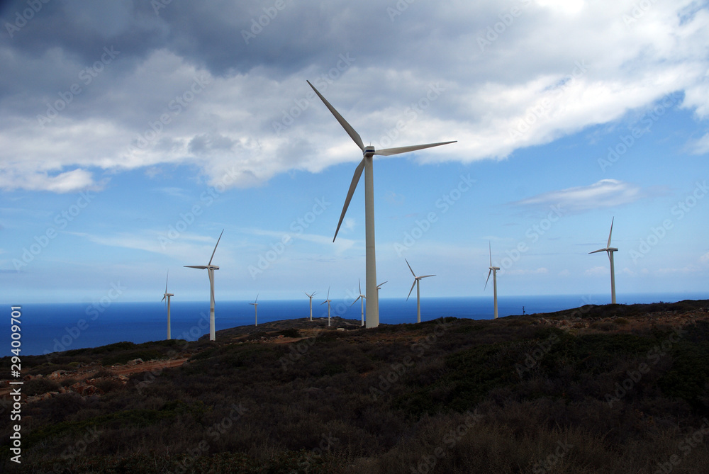 wind power plants on a mountain against a background of blue sky and sea wind power plants on a mountain against a background of blue sky and sea