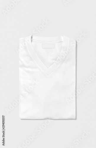 Folded plain red v neck t shirt on isolated background. Top view