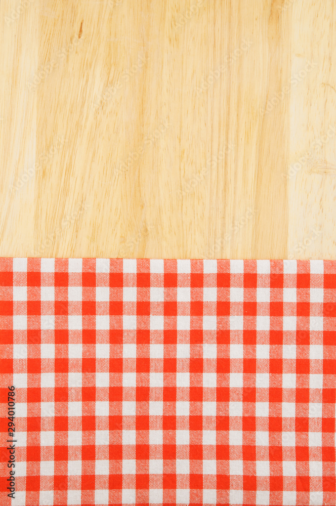 Red and white tablecloth on wooden table