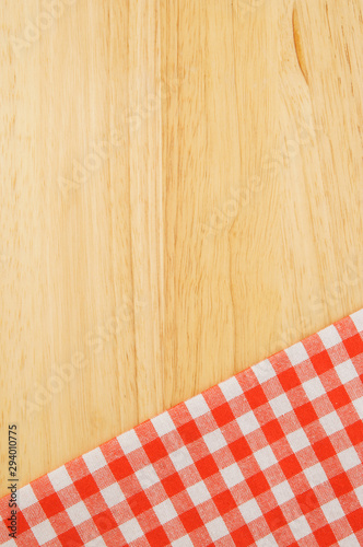 Red and white tablecloth on wooden table