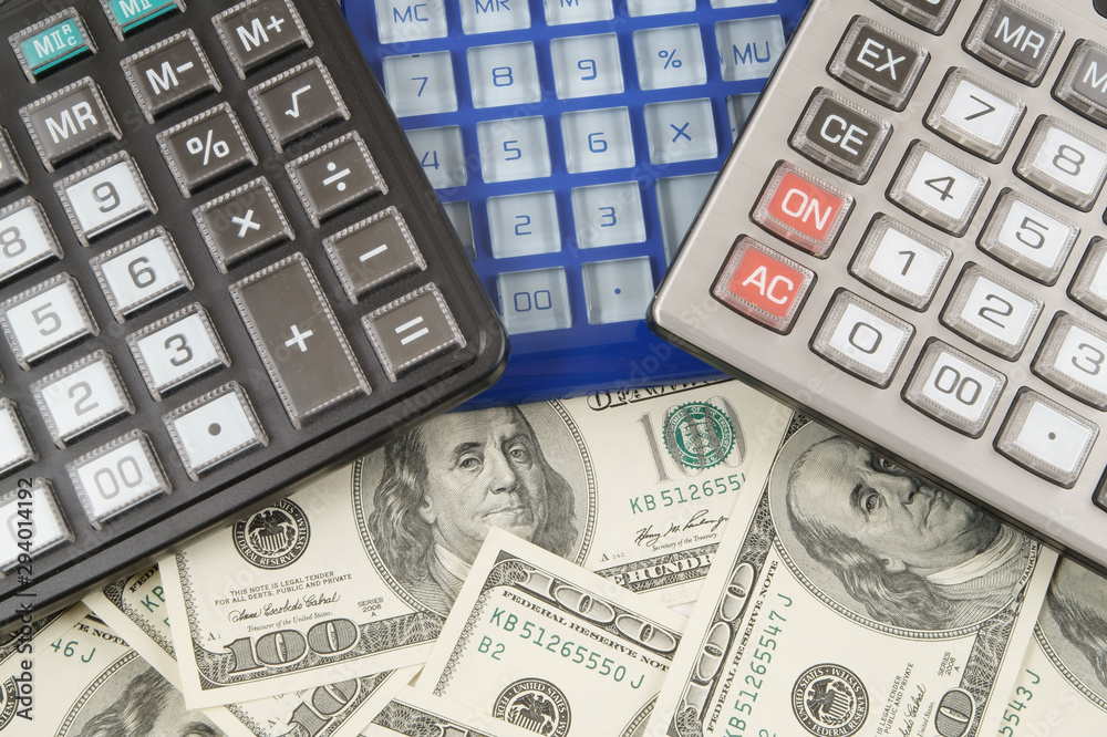 Business concept, calculators on money background Business concept, calculators on money background