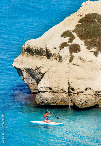 Girl on a sup in the shore of Torre dell'Orso