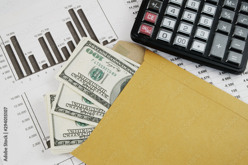 Business and profits concept with calculator, money in envelope and documents Business and profits concept with calculator, money in envelope and documents