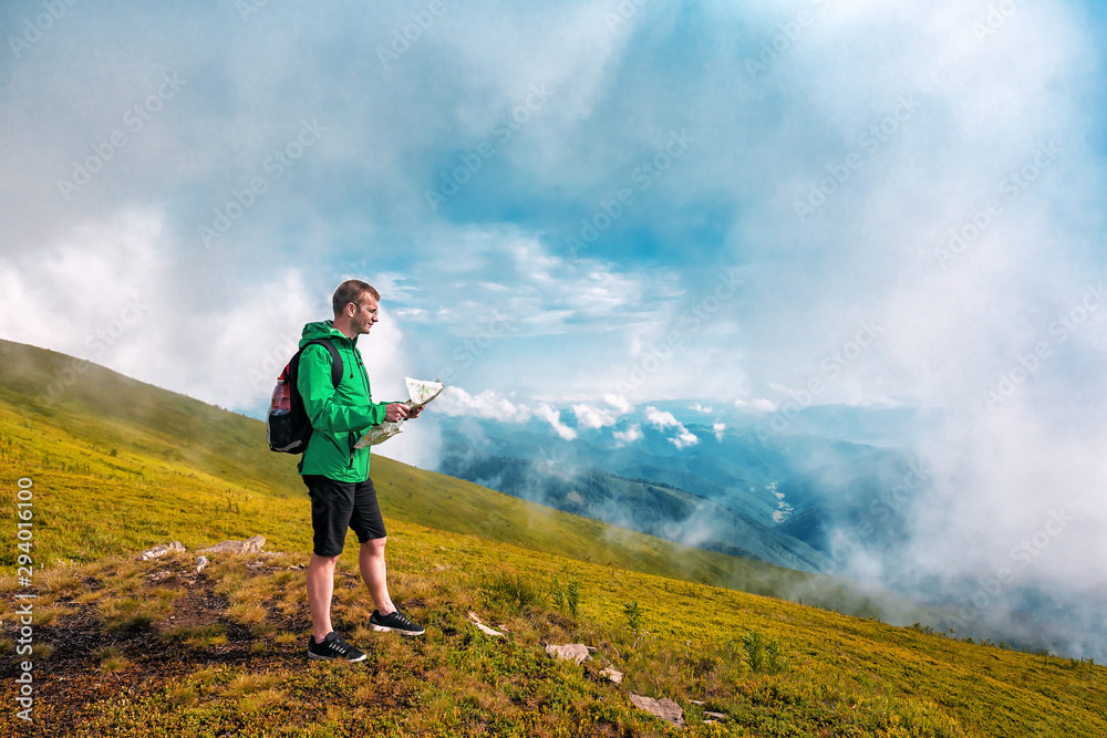 tourist with backpack and map in mountains tourist with backpack and map in mountains