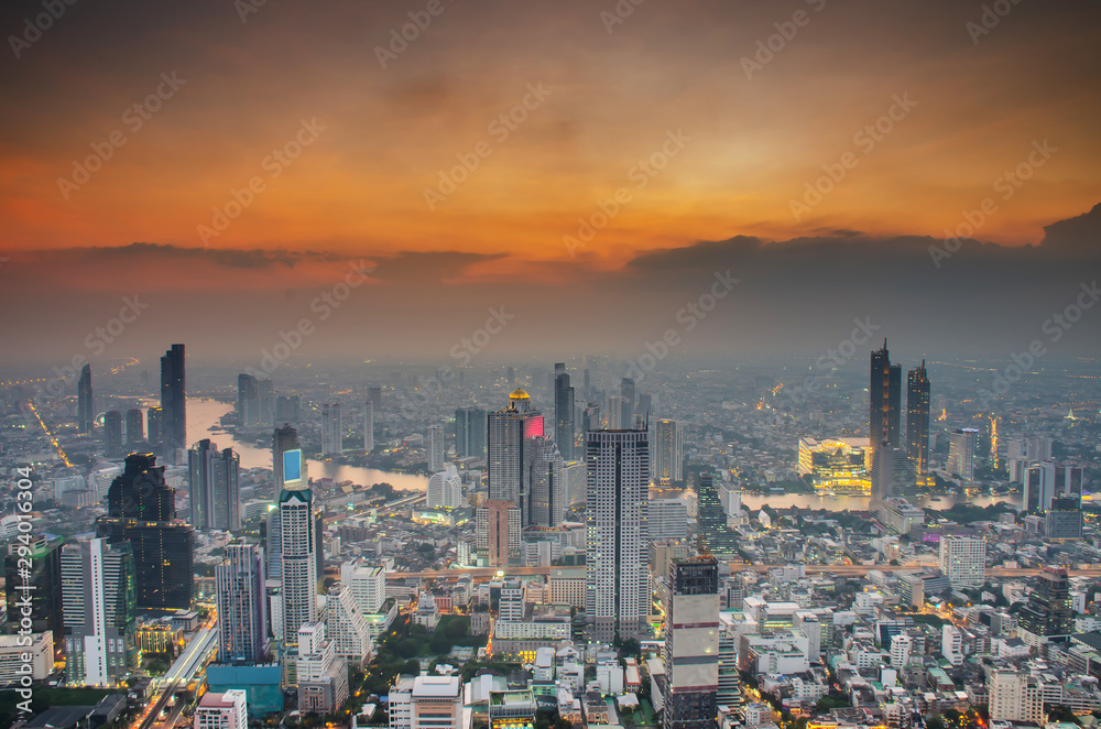 Aerial Skyline of Bangkok Cityscape from Mahanakhon Skywalk and business urban downtown with Beautiful Twilight Peak at Sunset, Cityscape capital and financial district center of Bangkok, Thailand.