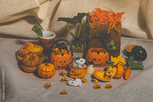 halloween holiday decoration concept, A lot of halloween party object miniature toys decoration on wrinkled calico background.