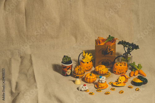 halloween holiday decoration concept, A lot of halloween party object miniature toys decoration on wrinkled calico background.