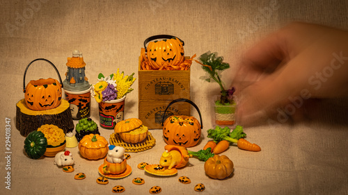 halloween holiday decoration concept, A lot of halloween party object miniature toys decoration on wrinkled calico background.