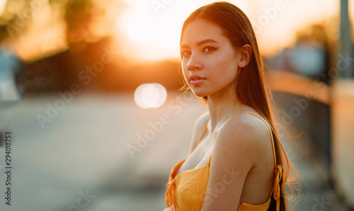 Portrait of a woman with loose long hair at sunset.