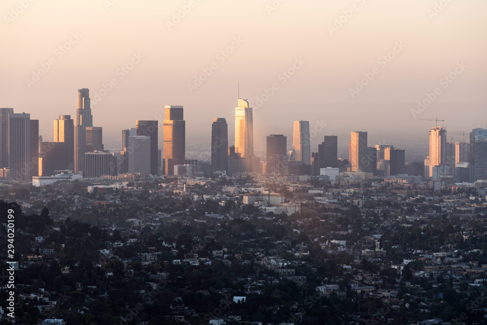 Downtown Los Angeles buildings reflecting early morning sunlight through the haze.  