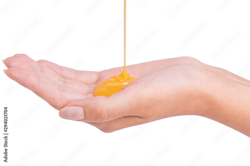 Yellow shampoo pouring on a female hand Photos | Adobe Stock