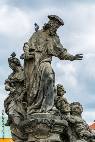 Statue of St. Ivo at the Charles bridge  Prague  Czech  The statue depicts the patron saint of lawyers who are accompanied by Justice.