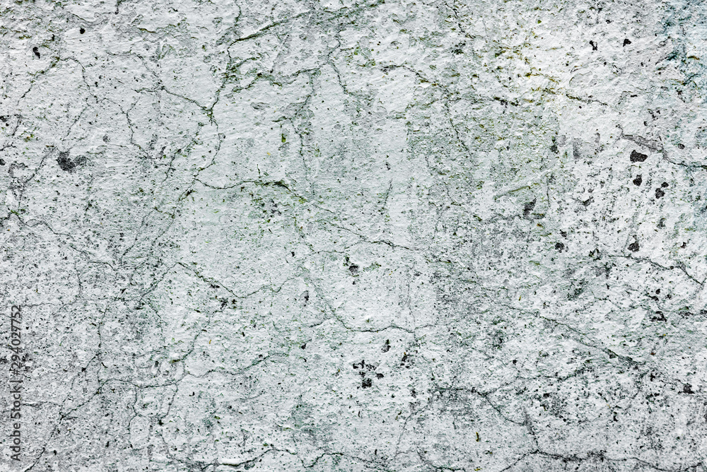 Texture of a concrete wall with cracks and scratches which can be used as a background Texture of a concrete wall with cracks and scratches which can be used as a background