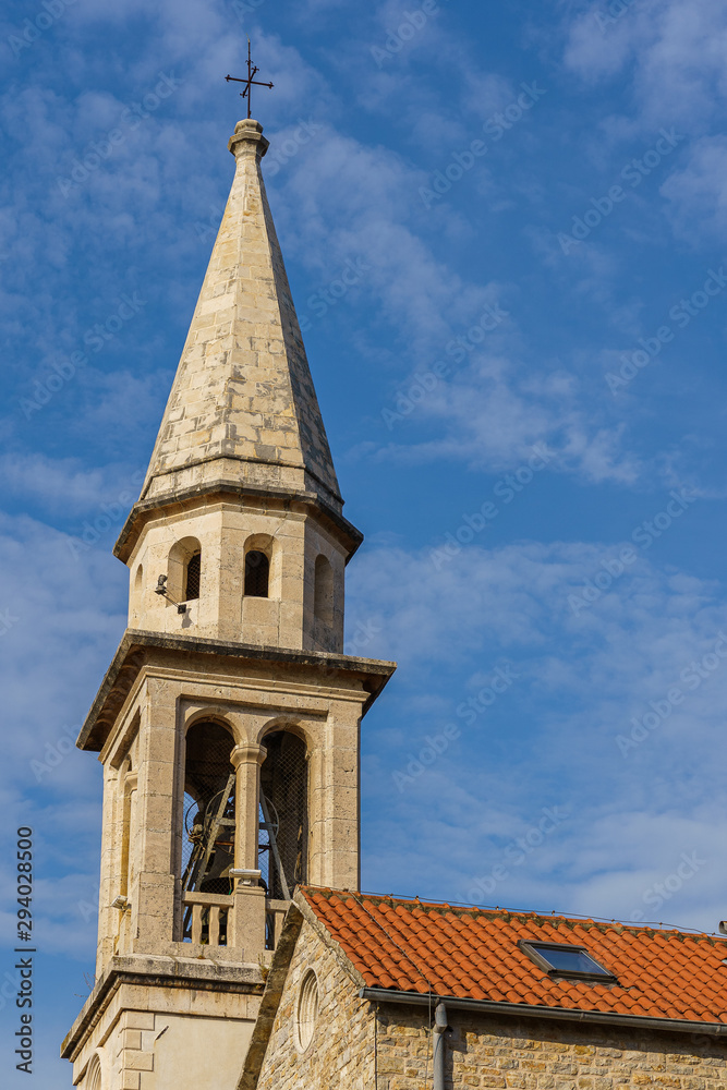 Architecture of the Balkan countries. Stone tower with a cross.