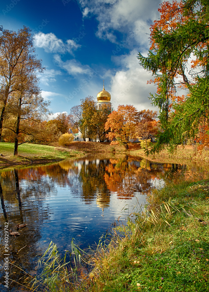 The colors of autumn. Beautiful view reflection on an old church
