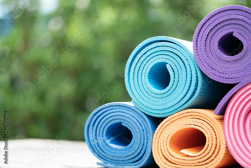 close up of colorful yoga mat on the table, sport and healthy concept