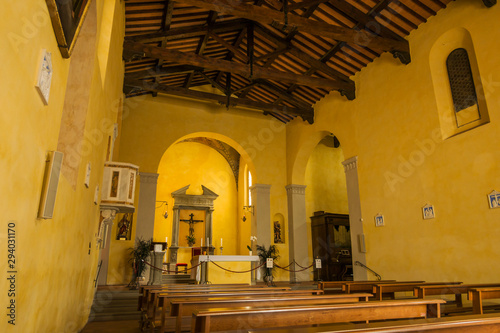 Radda in Chianti, Siena, Tuscany/ Italy -September 19, 2019: Interior of the the ancient church Propositura di San Niccolo and the old fountain in the Tuscan medieval town. photo