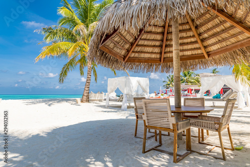 Fototapeta Naklejka Na Ścianę i Meble -  Cafe on the beach, ocean and sky, tropical resort or hotel background concept. Summer vacation or holiday, family travel