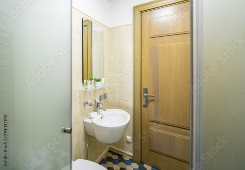 Interior of bathroom in modern apartment. Shower cabin. Sink. Toilet.