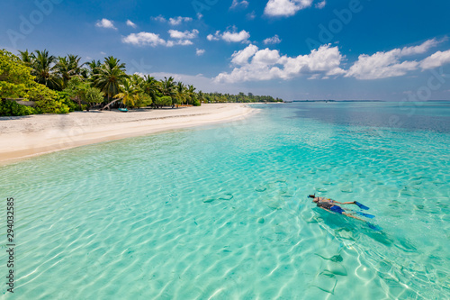 Fototapeta Naklejka Na Ścianę i Meble -  Caucasian couple of tourists snorkel in crystal turquoise water near Maldives Island. Perfect weather conditions at luxury resort beach scene, calm sea water, couple exotic water, underwater wildlife