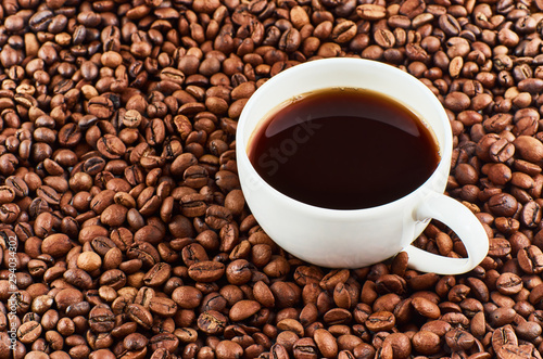 Cup of coffee on a background of coffee beans.