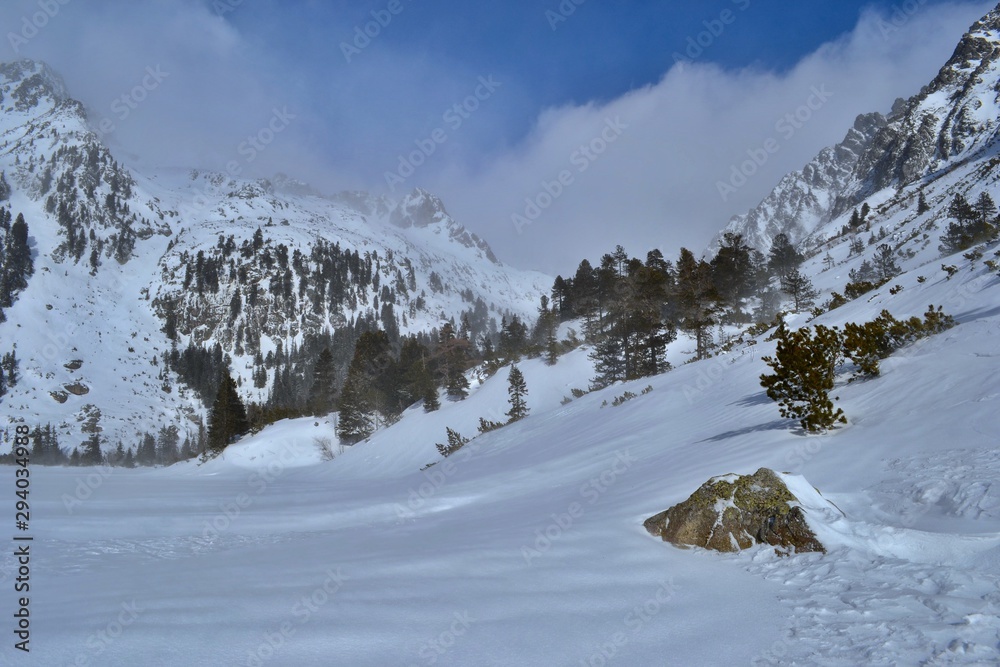 Fototapeta premium Popradske pleso in winter. Sunny day, white clouds, beautiful mountains. High Tatras, Slovakia.