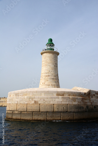 sea lighthouse on a background of blue sea