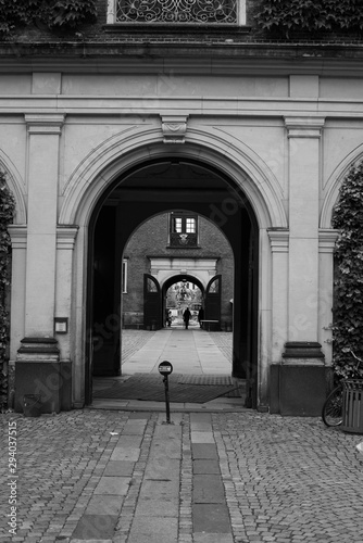 black and white arch with a person walking