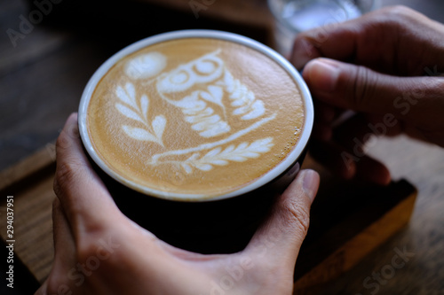 Hand Hold a Cup of Coffee. Menu Drink for Relax on Wood Table Texture and Space for your text. Lifestyle Concept Cafe Design Background. 