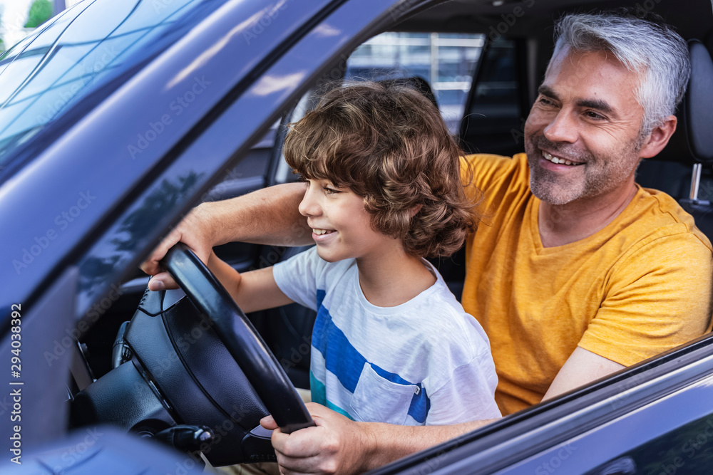 Happy Caucasian man and little boy posing for camera Happy Caucasian man and little boy posing for camera