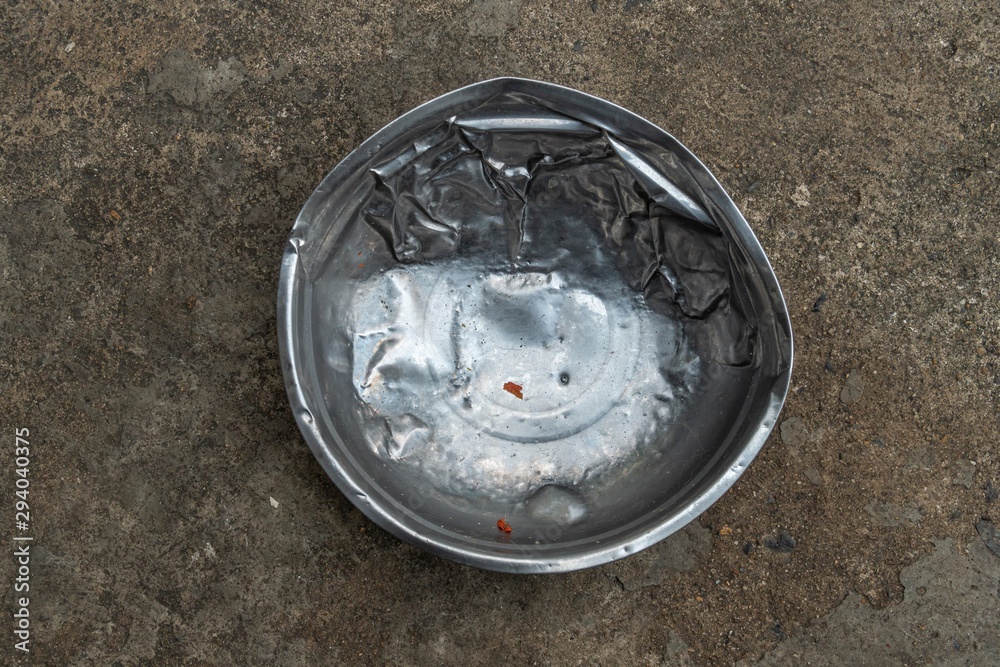 an old used stainless steel dog's food bowl an old used stainless steel dog's food bowl