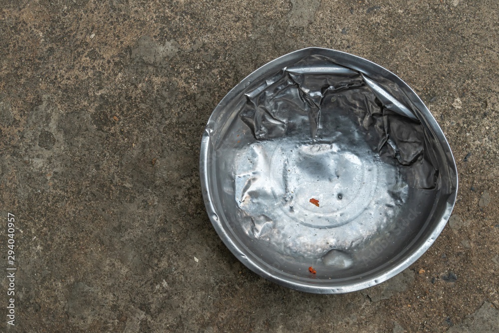 an old used stainless steel dog's food bowl an old used stainless steel dog's food bowl
