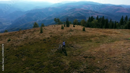 Aerial drone shot of Magura peak around mountain biker, Cindrel mountains, Sibiu county, Romania