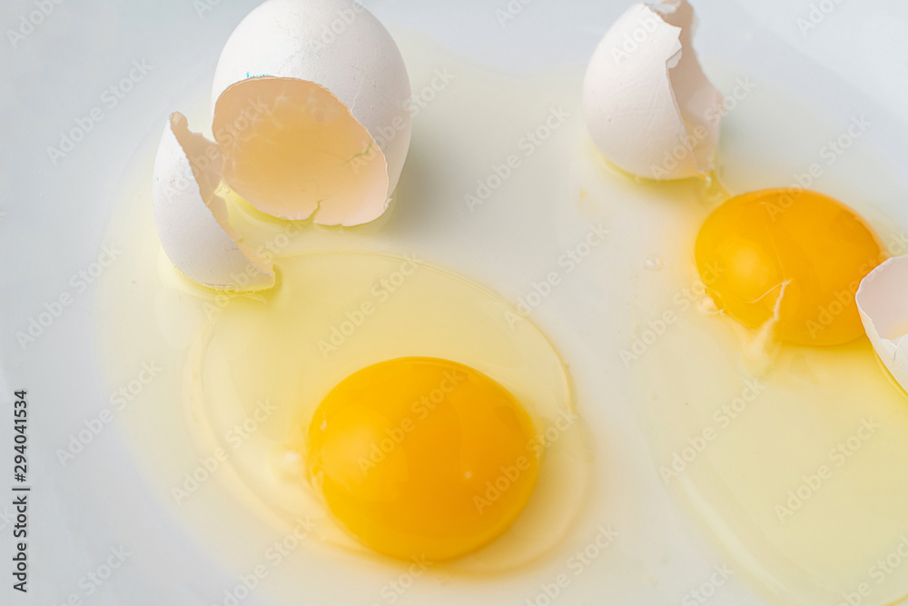a broken white egg in the plate to prepare some food dishes a broken white egg in the plate to prepare some food dishes