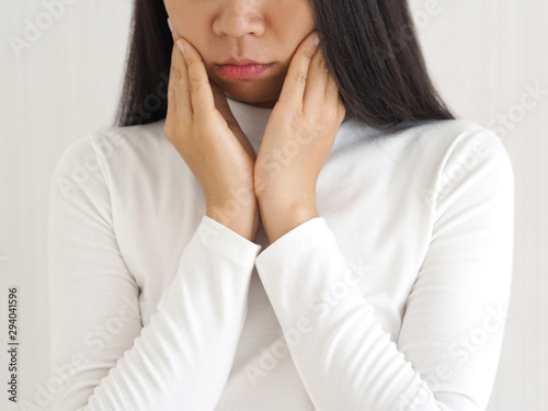 Obraz na plátně trigeminal neuralgia and temporomandibular joint and muscle disorder in asian woman, She use hand touching her cheek and symptoms fo pain and suffering on isoleted white background