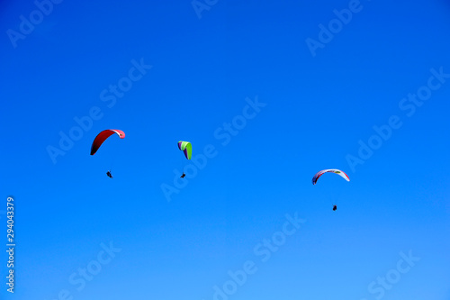 Paragliders in full flight over volcanoes of Puy de Dome in the central massif near Clermont-Ferrand