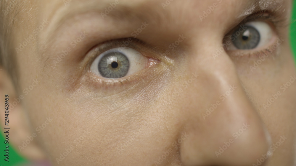 Fototapeta premium Close-up of a surprised emotional man with blue eyes looking into the camera