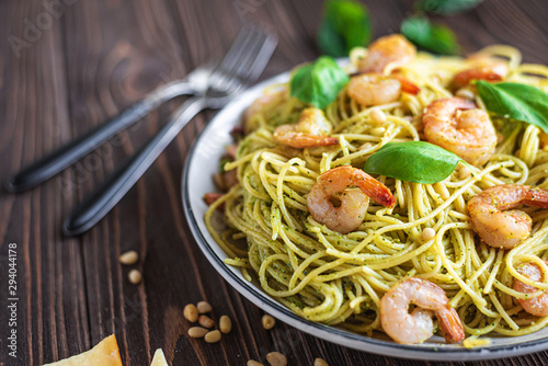 Spaghetti seafood pasta with prawns and basil. Pasta with pesto and prawns.