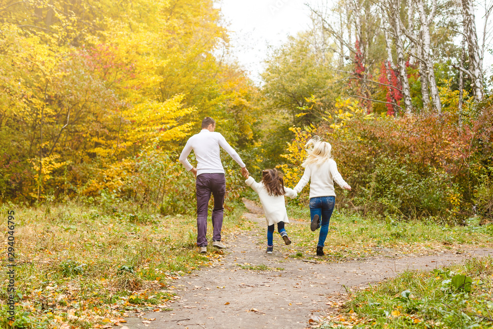 Fototapeta premium Family with child go in autumn park