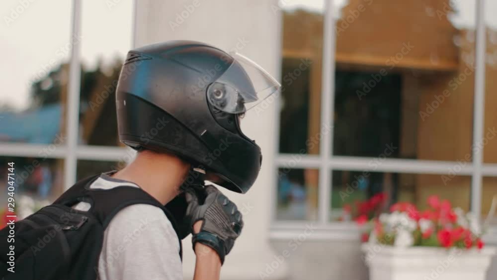 portrait of young attractive motorcyclist with black helmet on street. Man motorcycle biker portrait of young attractive motorcyclist with black helmet on street. Man motorcycle biker
