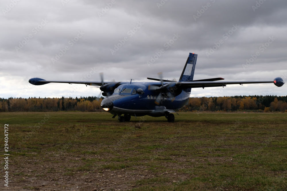 An aircraft L-410 is on a runway. An aircraft L-410 is on a runway.