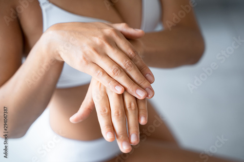 Female hands applying a moisturizing hand cream