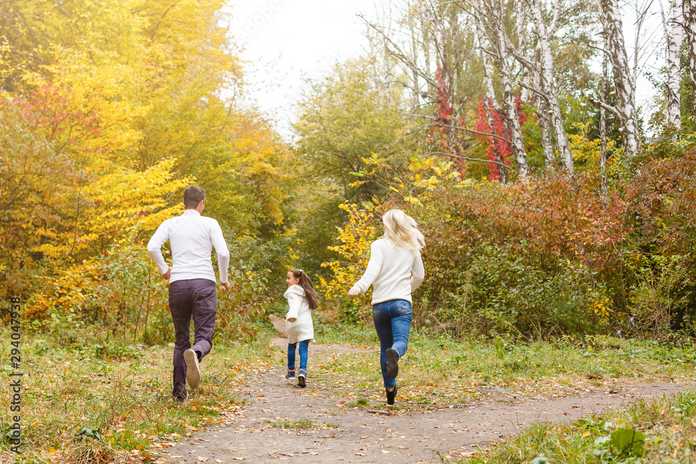 Fototapeta premium Family with child go in autumn park