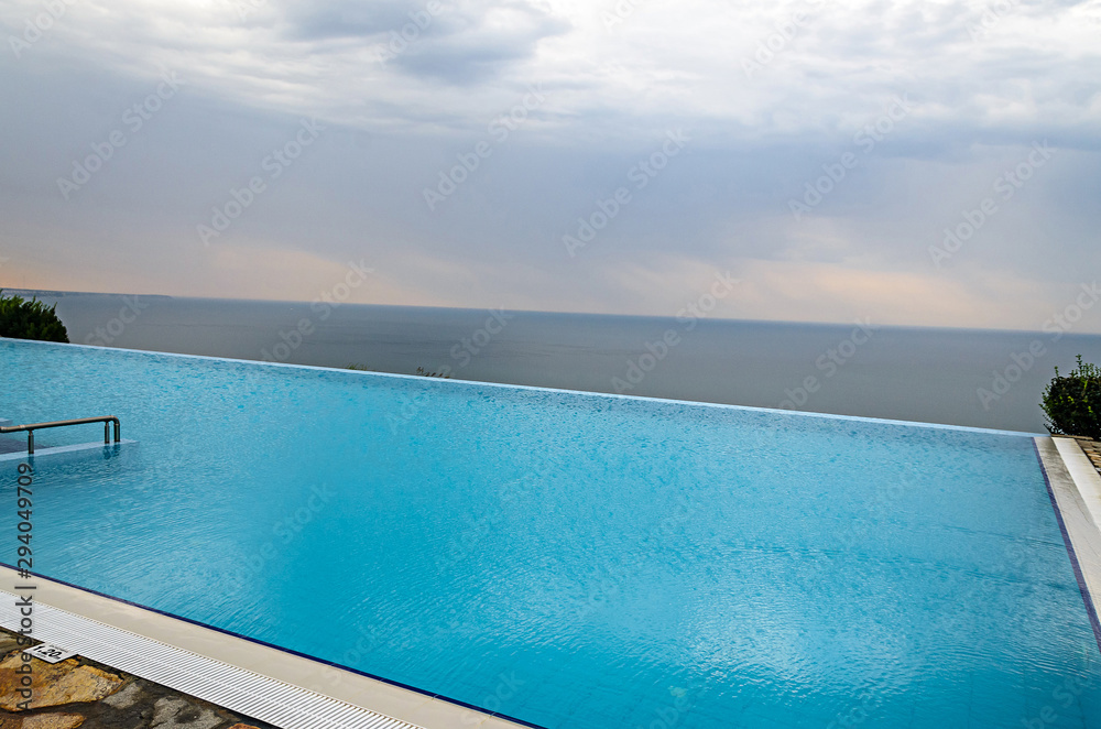 Infinity pool with crystal blue water view to sea  ocean