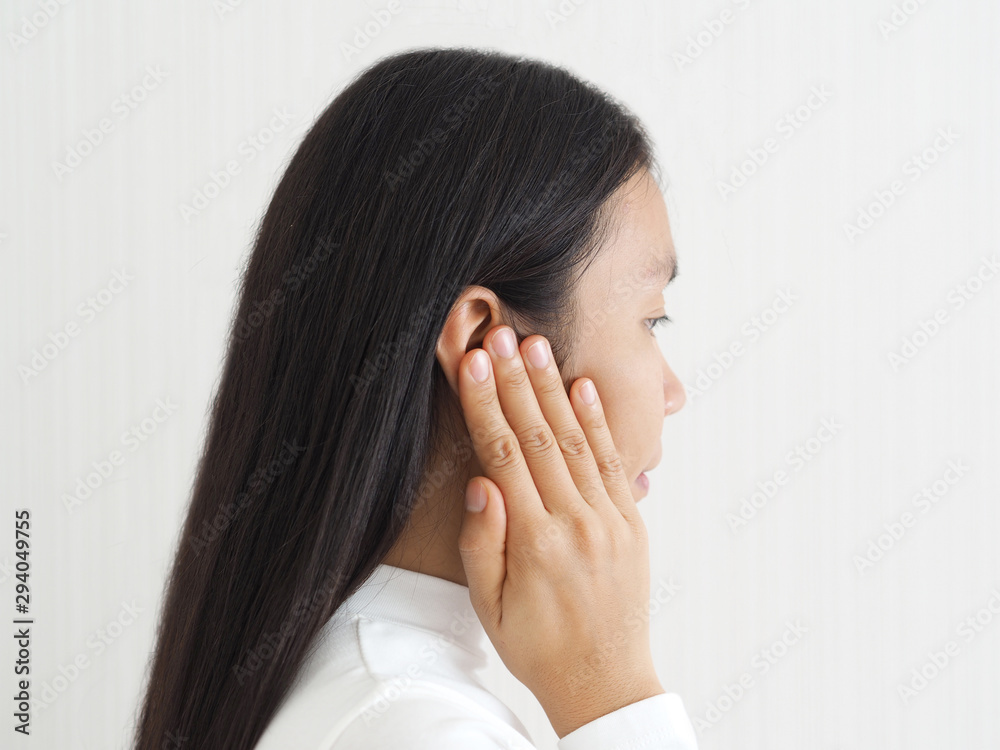 ruptured eardrum,tinnitus and meniere disease and otitis media in asian woman. She use hand touching her ear causes of ear pain on white background use for health care concept. ruptured eardrum,tinnitus and meniere disease and otitis media in asian woman. She use hand touching her ear causes of ear pain on white background use for health care concept.
