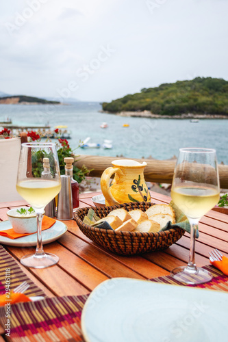 Restaurant with served table in seafront of Ionian sea, Ksamil