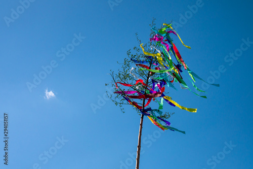 May tree, traditional hungarian austrian german folklore decoration in may with blue sky photo