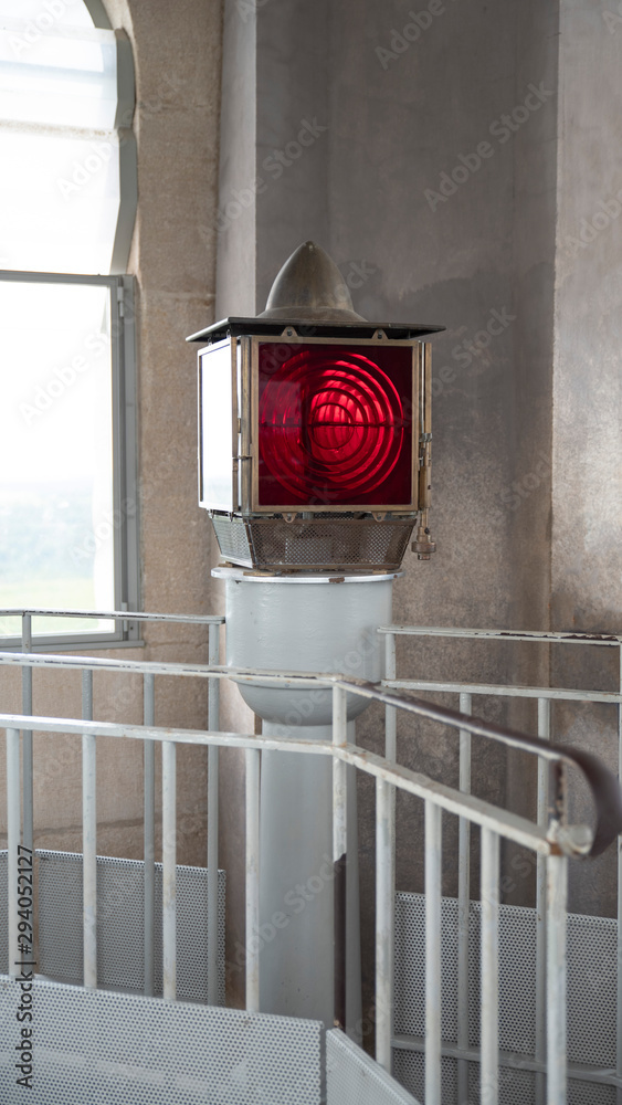 Detail of the red lamp of a lighthouse